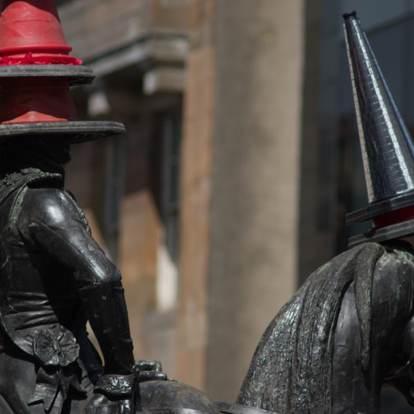 Close-up of the equestrian Duke of Wellington statue in Glasgow city centre, with traffic cones balanced on the rider’s head and the horse’s head.